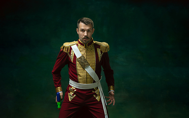 Image showing Young man as Nicholas II on dark green background. Retro style, comparison of eras concept.