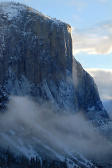 Image showing El Capitan illuminated by rising sun on a misty morning