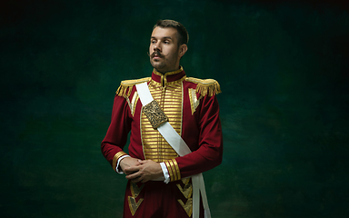 Image showing Young man as Nicholas II on dark green background. Retro style, comparison of eras concept.