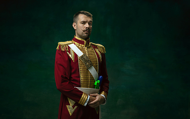 Image showing Young man as Nicholas II on dark green background. Retro style, comparison of eras concept.