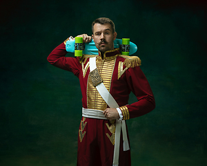 Image showing Young man as Nicholas II on dark green background. Retro style, comparison of eras concept.