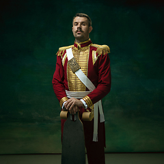 Image showing Young man as Nicholas II on dark green background. Retro style, comparison of eras concept.