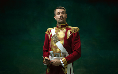 Image showing Young man as Nicholas II on dark green background. Retro style, comparison of eras concept.