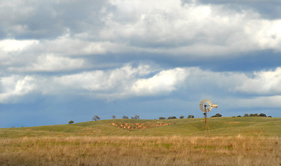 Image showing Windmill on a California hillside under a cloud filled sky
