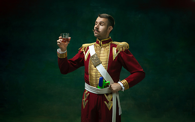 Image showing Young man as Nicholas II on dark green background. Retro style, comparison of eras concept.