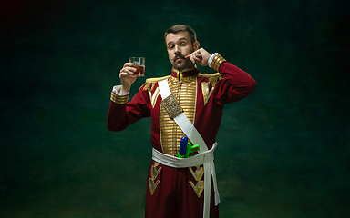 Image showing Young man as Nicholas II on dark green background. Retro style, comparison of eras concept.