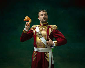 Image showing Young man as Nicholas II on dark green background. Retro style, comparison of eras concept.