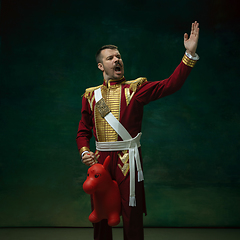 Image showing Young man as Nicholas II on dark green background. Retro style, comparison of eras concept.