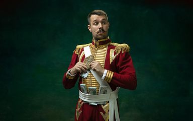 Image showing Young man as Nicholas II on dark green background. Retro style, comparison of eras concept.