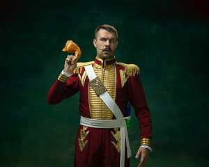 Image showing Young man as Nicholas II on dark green background. Retro style, comparison of eras concept.