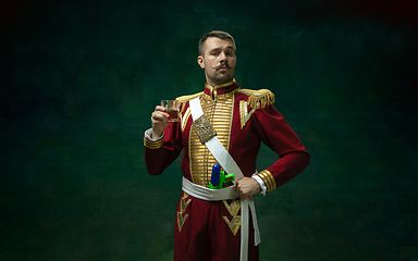 Image showing Young man as Nicholas II on dark green background. Retro style, comparison of eras concept.