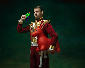 Image showing Young man as Nicholas II on dark green background. Retro style, comparison of eras concept.