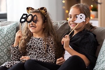 Image showing girls in halloween costumes with party props