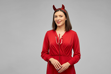 Image showing happy woman in red halloween costume of devil