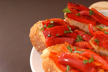 Image showing Side view of roasted red pepper and basil bruschetta