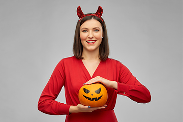 Image showing woman in halloween costume of devil with pumpkin