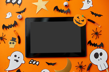 Image showing tablet pc, halloween party props and decorations