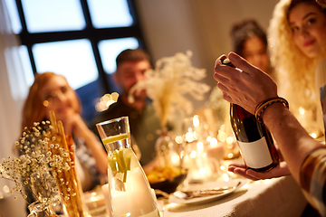 Image showing happy friends with red wine at christmas party