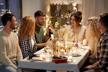 Image showing happy friends with red wine at christmas party