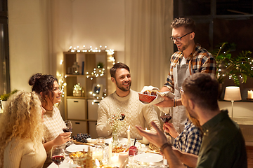 Image showing happy friends having christmas dinner at home