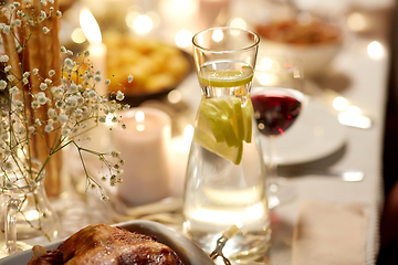 Image showing roast chicken on served table at home dinner party