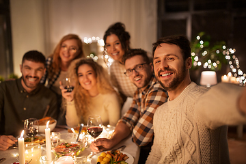 Image showing friends taking selfie at christmas dinner party