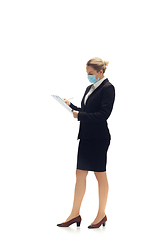 Image showing Young woman, accountant, booker in office suit isolated on white studio background