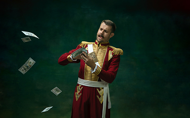 Image showing Young man as Nicholas II on dark green background. Retro style, comparison of eras concept.