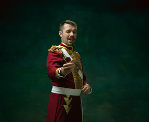 Image showing Young man as Nicholas II on dark green background. Retro style, comparison of eras concept.