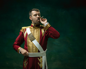 Image showing Young man as Nicholas II on dark green background. Retro style, comparison of eras concept.