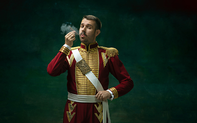 Image showing Young man as Nicholas II on dark green background. Retro style, comparison of eras concept.