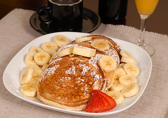 Image showing Banana pancakes with coffe and orange juice
