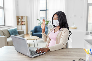 Image showing woman in mask with laptop having video call