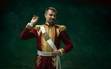 Image showing Young man as Nicholas II on dark green background. Retro style, comparison of eras concept.