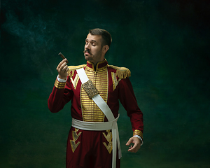 Image showing Young man as Nicholas II on dark green background. Retro style, comparison of eras concept.