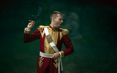 Image showing Young man as Nicholas II on dark green background. Retro style, comparison of eras concept.