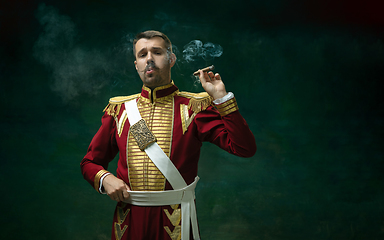 Image showing Young man as Nicholas II on dark green background. Retro style, comparison of eras concept.