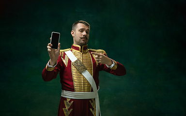 Image showing Young man as Nicholas II on dark green background. Retro style, comparison of eras concept.