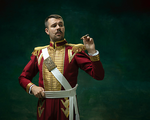 Image showing Young man as Nicholas II on dark green background. Retro style, comparison of eras concept.