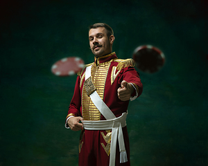 Image showing Young man as Nicholas II on dark green background. Retro style, comparison of eras concept.