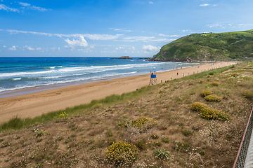 Image showing View to the Zarautz Beach with walking people, Basque Country, Spain on a beautiful summer day
