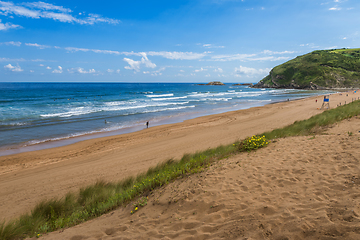 Image showing View to the Zarautz Beach with walking people, Basque Country, Spain on a beautiful summer day