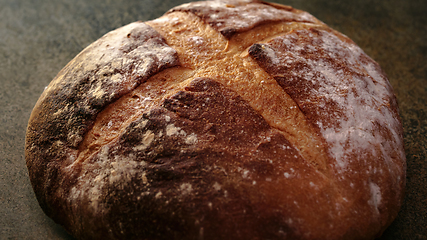 Image showing Freshly baked natural bread is on the kitchen table.