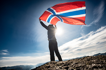 Image showing Woman with a waving flag of Norway on the background of nature