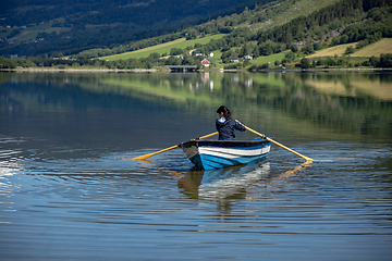 Image showing Woman fishing on a boat.