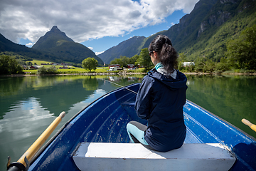 Image showing Woman fishing on Fishing rod spinning in Norway.