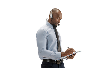 Image showing Young african-american call center consultant with headset isolated on white studio background