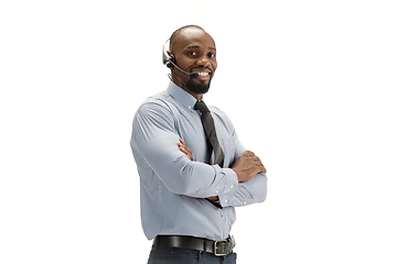 Image showing Young african-american call center consultant with headset isolated on white studio background