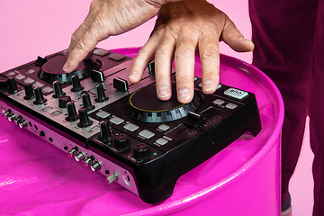 Image showing Senior hipster man wearing eyeglasses posing on pink background. Tech and joyful elderly lifestyle concept