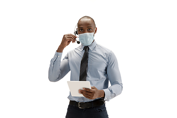 Image showing Young african-american call center consultant with headset isolated on white studio background